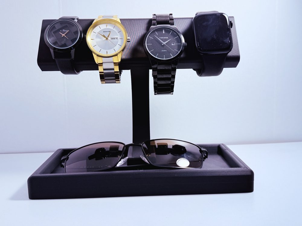 Watch and sunglasses valet stand displaying four watches and a pair of sunglasses